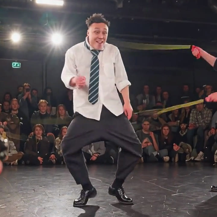 Mauvis in the Wan 3 version, copying the same bow-legged crouch in a white shirt and striped tie